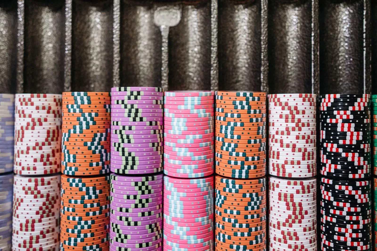 Rows of casino chips stacked in a dealer's tray.