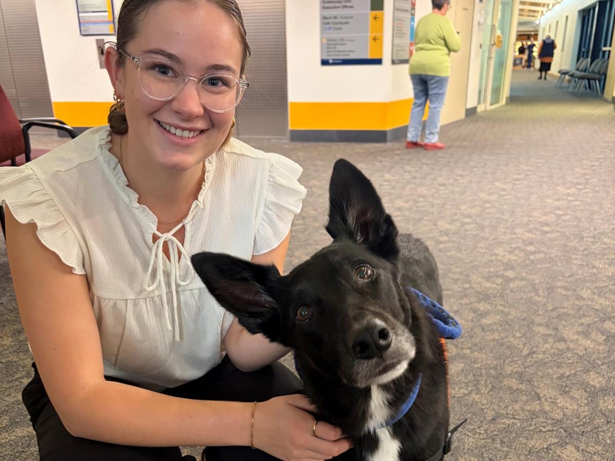An Empower assistance dog on a hospital visit, with a member of the Patinos team